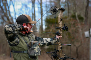 man holding compound bow