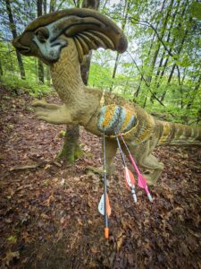 arrows in a foam dinosaur archery target
