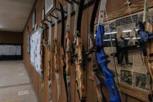 traditional archery bows at an indoor archery range hanging